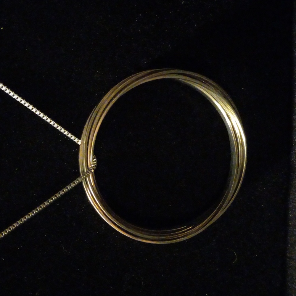 5 interlocking circles on a 24 inch box chain. Silver tone